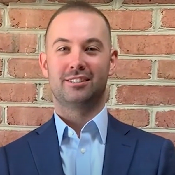 Testimonial with Kevin - his headshot against brick wall